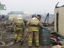 Сотрудники МЧС России работают на месте пожара Сотрудники МЧС России работают на месте пожара