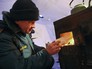 Сотрудник МЧС растапливает печь в мобильном пункте обогрева Сотрудник МЧС растапливает печь в мобильном пункте обогрева