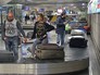Пассажиры получают багаж Пассажиры получают багаж