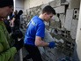 Участники акции закладывают бетонными блоками вход в отделение Сбербанка России в Киеве Участники акции закладывают бетонными блоками вход в отделение Сбербанка России в Киеве