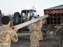 Украинские военные заряжают установку "Град" Украинские военные заряжают установку "Град"