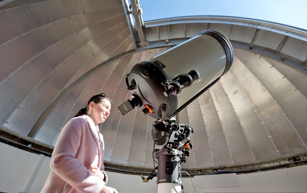 Посетители обсерватории смотрят в телескоп