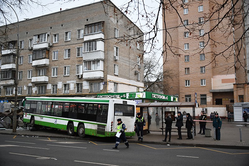Сотрудники правоохранительных органов у пассажирского автобуса, въехавшего в остановку на Сходненской улице в Москве